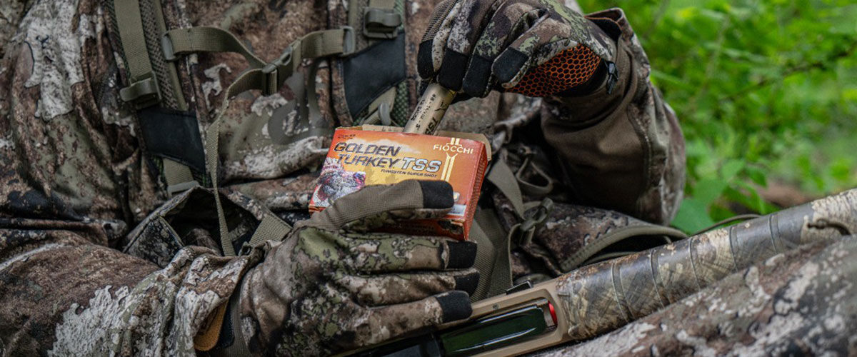 hunter pulling Golden Turkey shotshell from a box