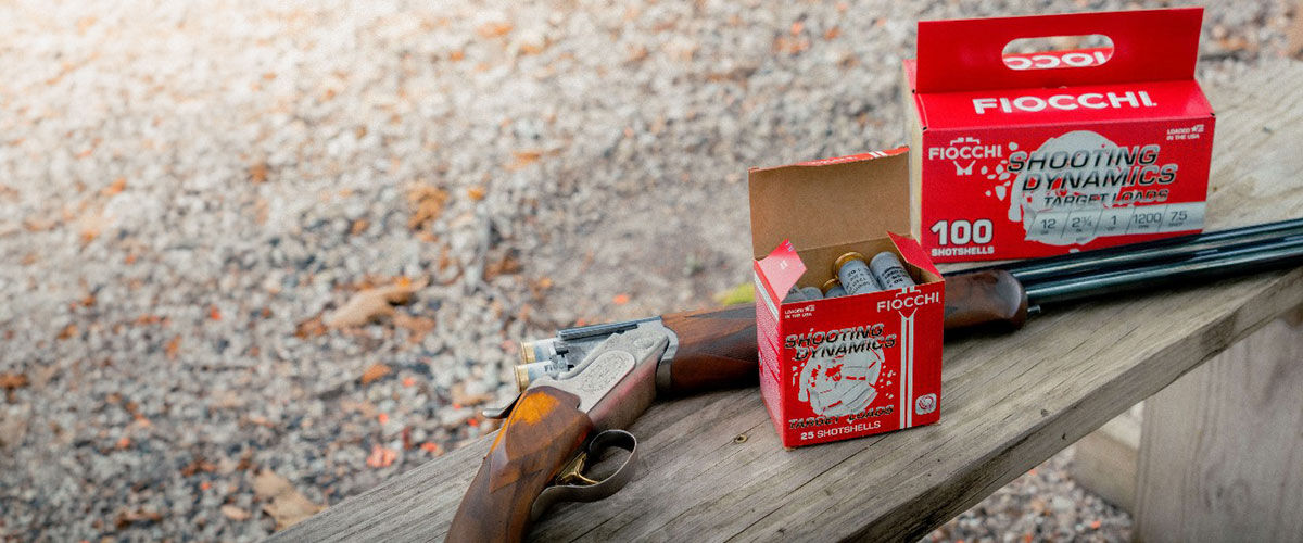 Shooting Dynamics boxes on a bench with a shotgun